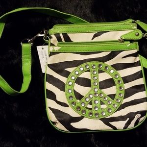 Black and white zebra bag with green trim.